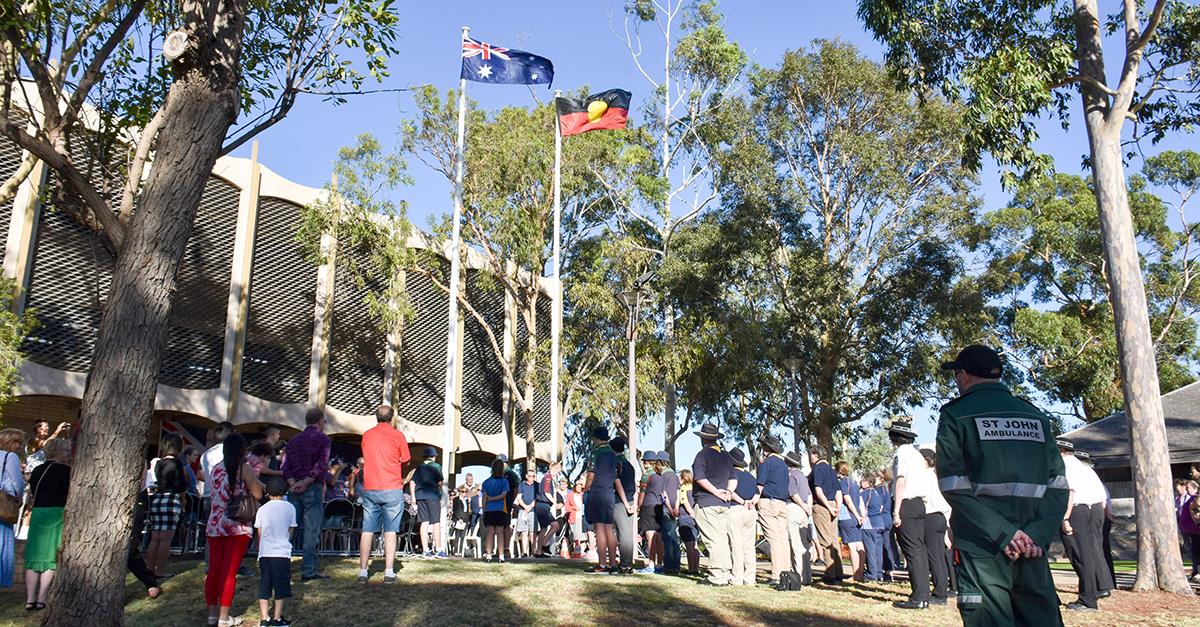 A crowd stands during a flag raising ceremony at the Council Administration Centre