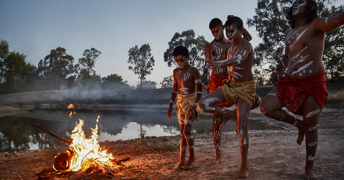 A group of young indigenous dancers perform on the bank of the Darling river at Wilcannia
