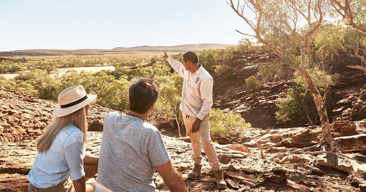 An indigenous guide points out over the plains at Mutawintji National Park