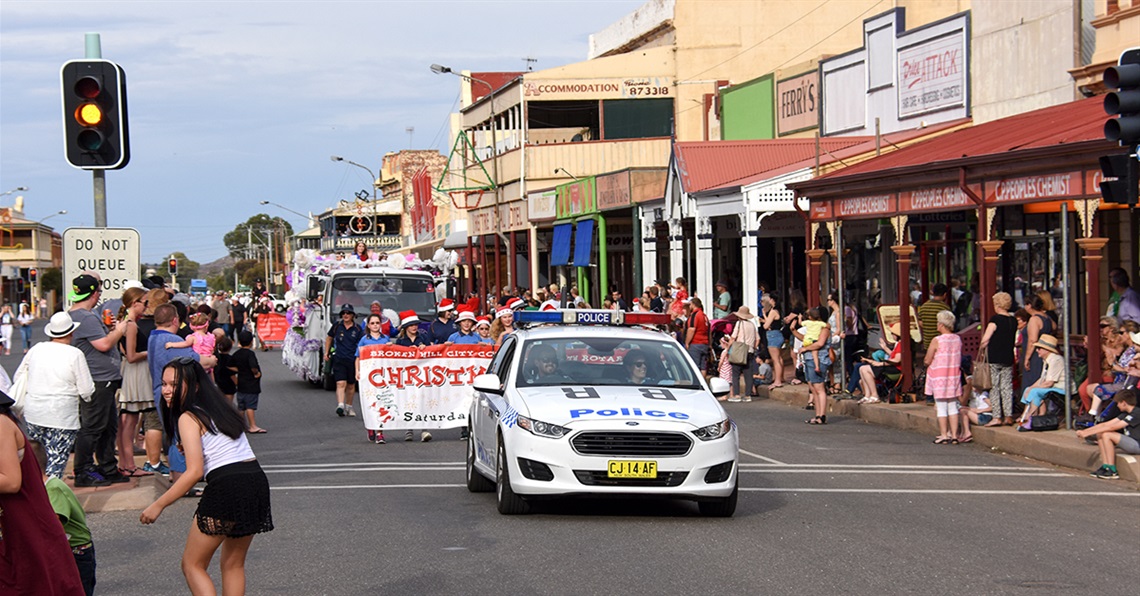 A police car leads the annual Christmas Pageant through Argent street