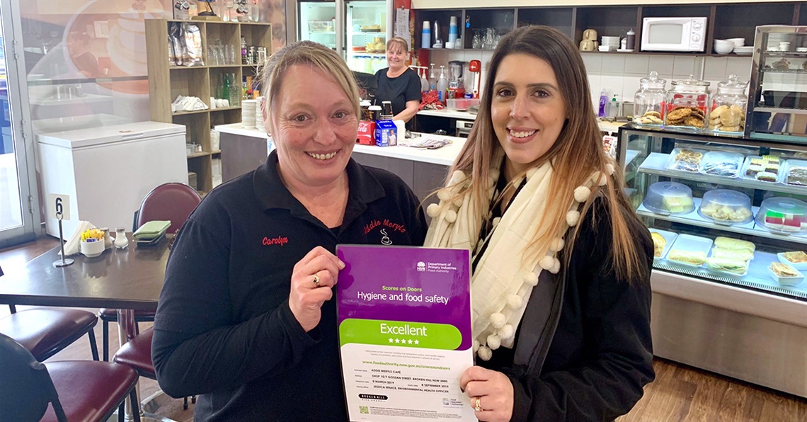 A scores on doors certificate being handed over