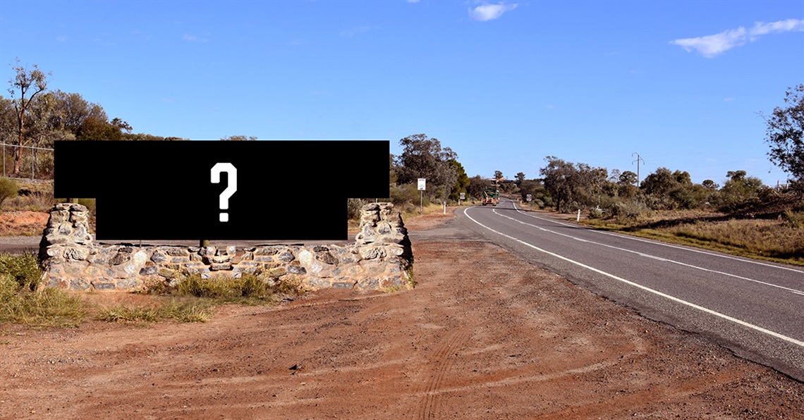 A roadside welcome sign with a balnk space and question mark where the sign should be