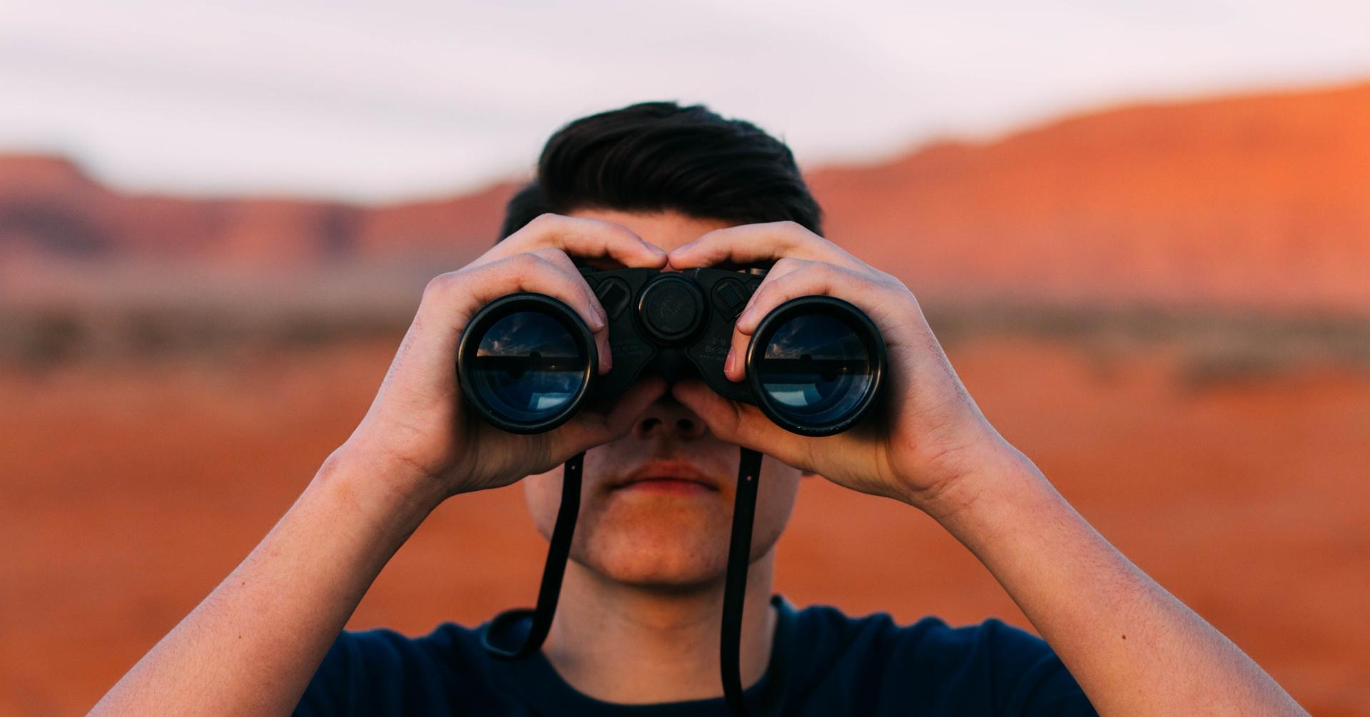 Man looking through binoculars