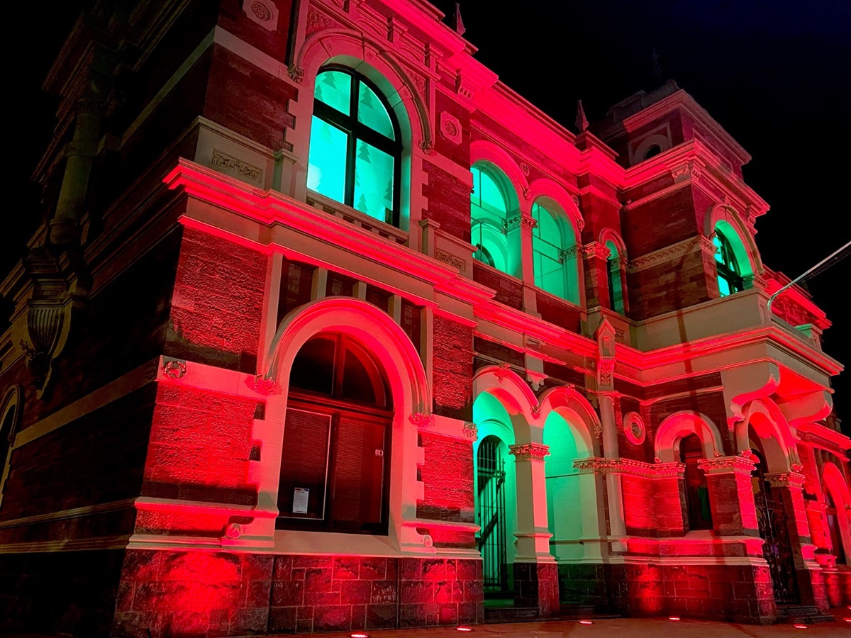 Image of Broken Hill Town Hall Facade lit up red and green for Christmas