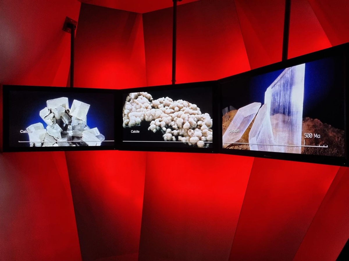 Minerals across three screens against a red background in the Crystal Theatre