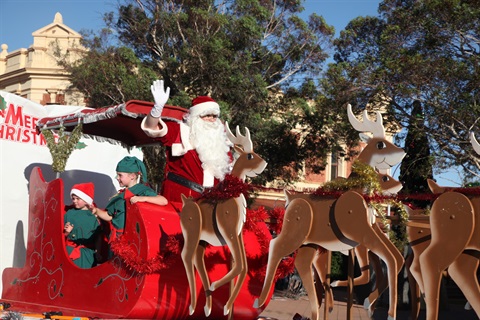 Santa on his sleigh with elves