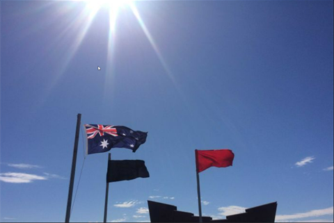 Australian Flag, Black Flag and Red Flag flying in the foreground of the Miners' Memorial on top of the Line of Lode