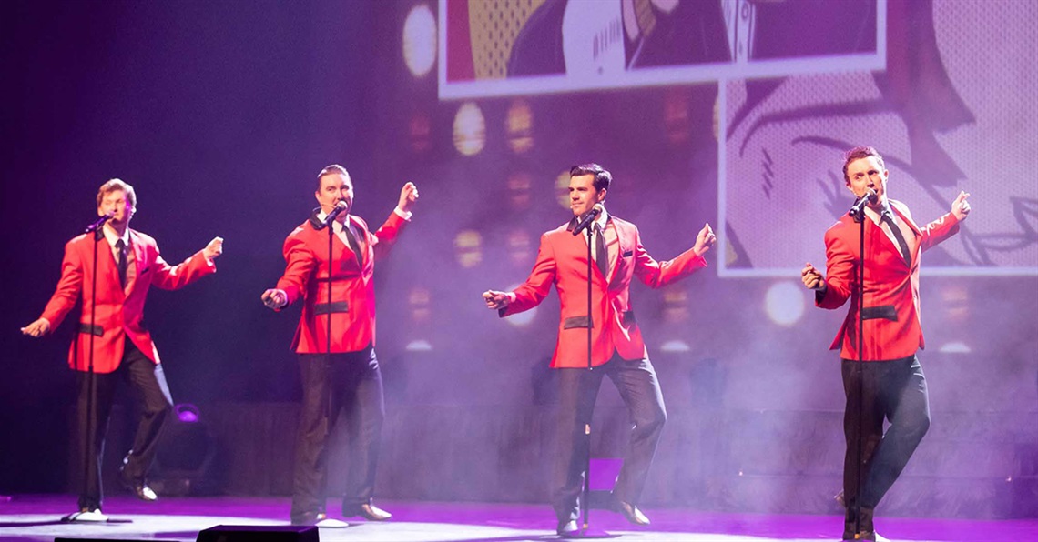 Four performers on stage during World of Musicals.