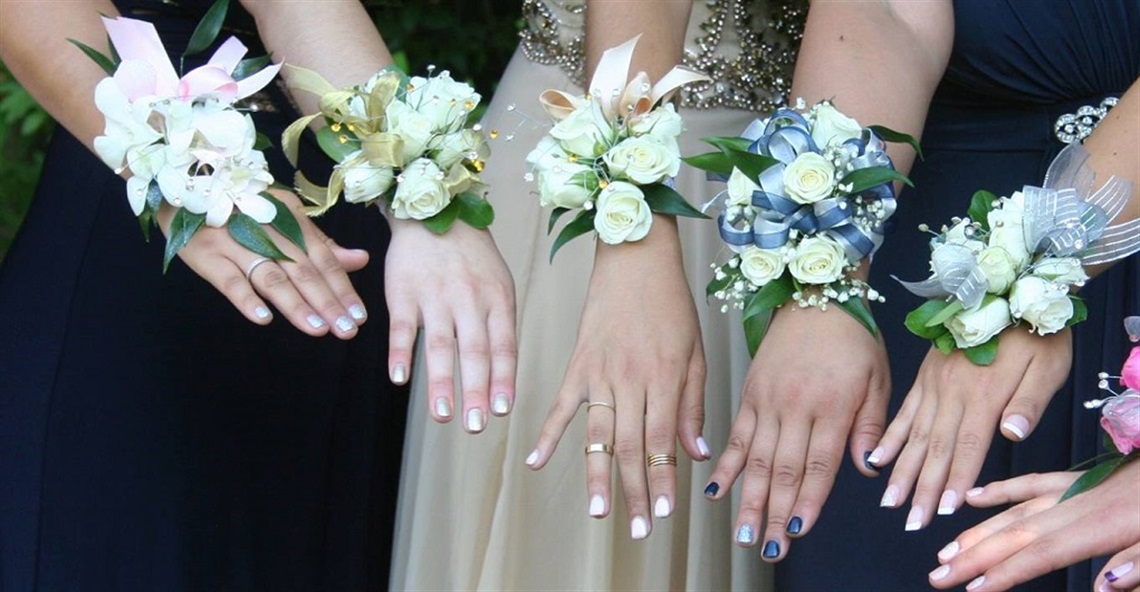 A group of girls displaying their corsages