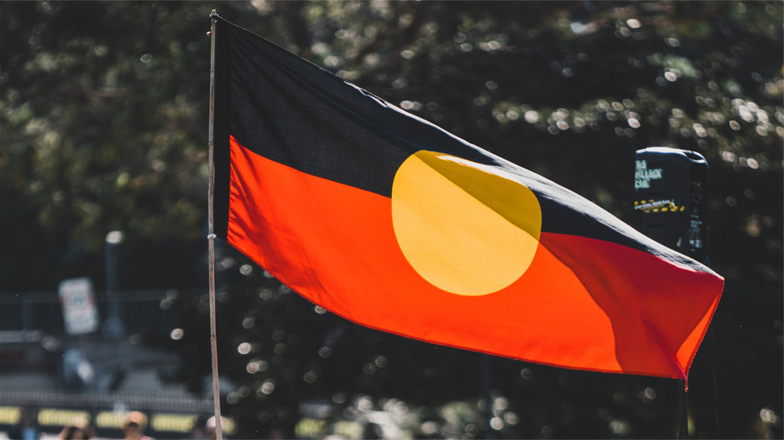 Image of Aboriginal Flag flying with the wind blowing through