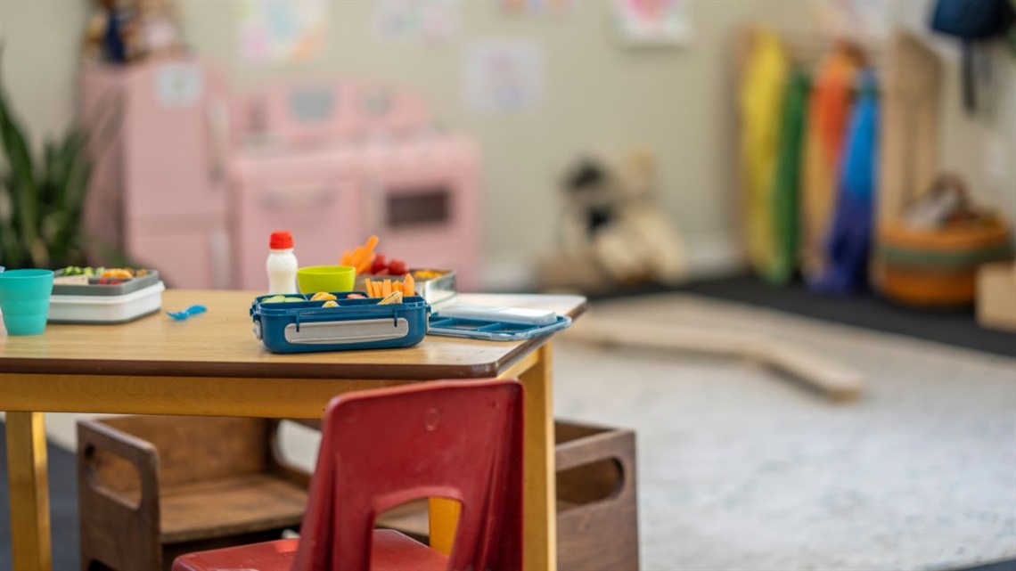 image of daycare room showing actrivity table with a lunchbox