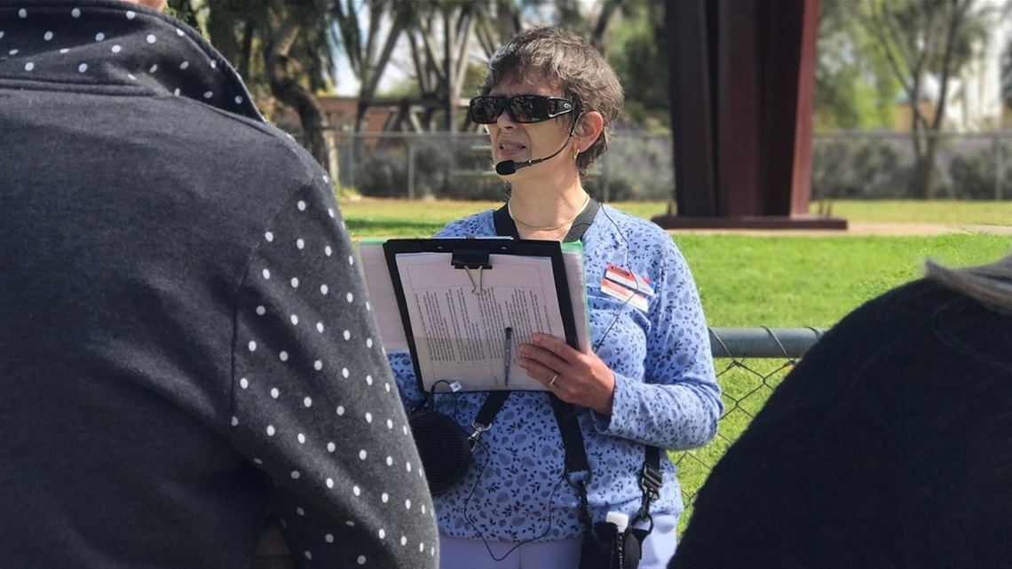 image of volunteer walking tour guide giving a talk to visitors.jpg