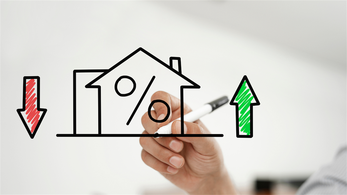 outline of a house drawn with black marker. red and green arrows can be seen eithr side of the house representing value increase and decline.